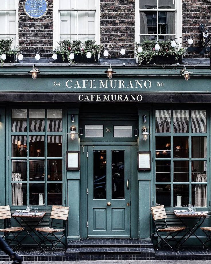 an outside view of a restaurant with tables and chairs