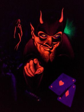 a man with devilish makeup holding a card in his hand