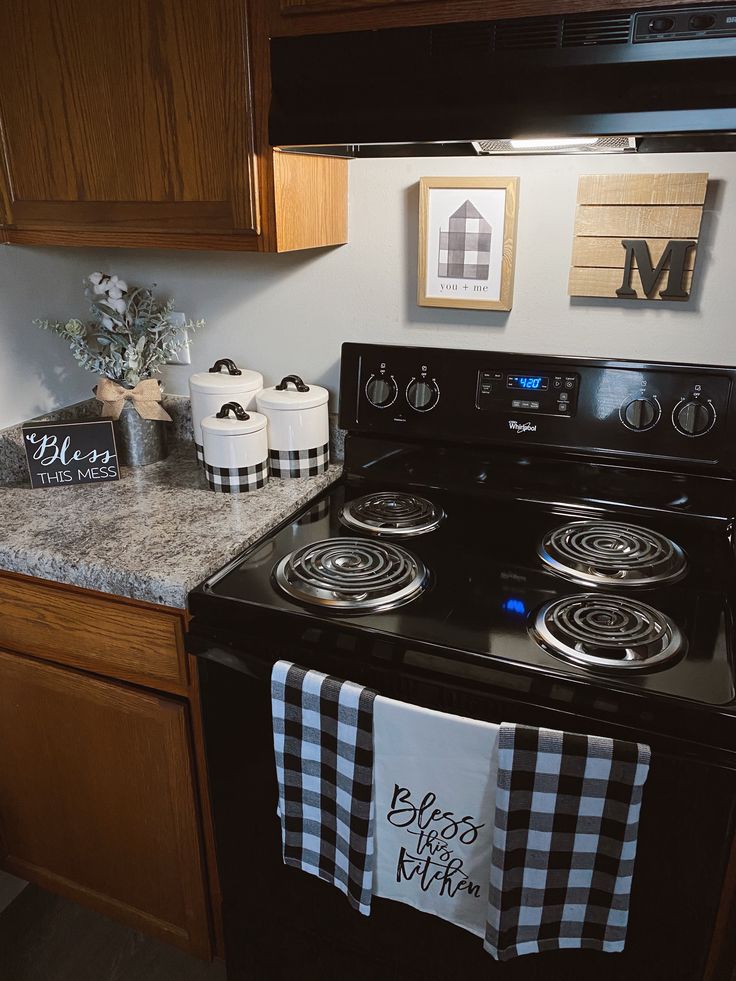 a black stove top oven sitting inside of a kitchen