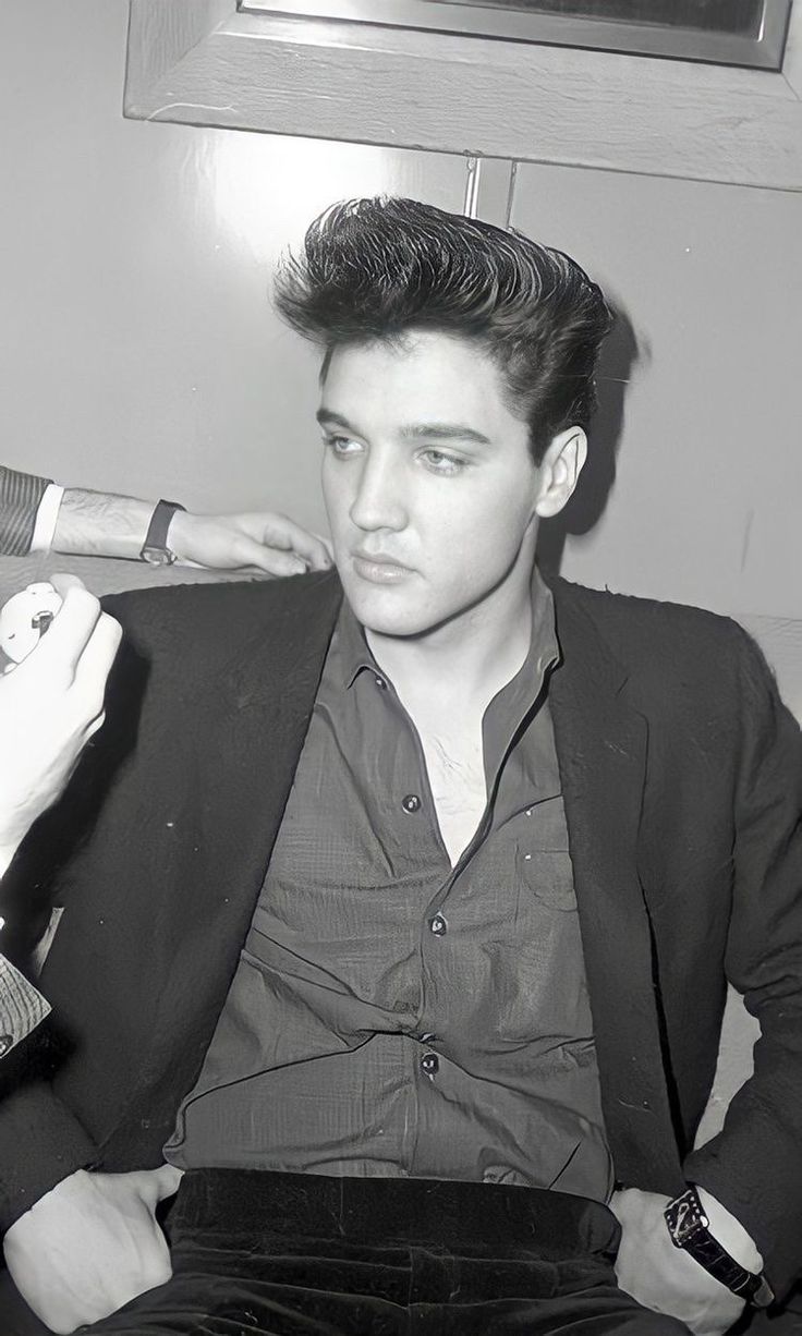 black and white photograph of a man brushing his hair