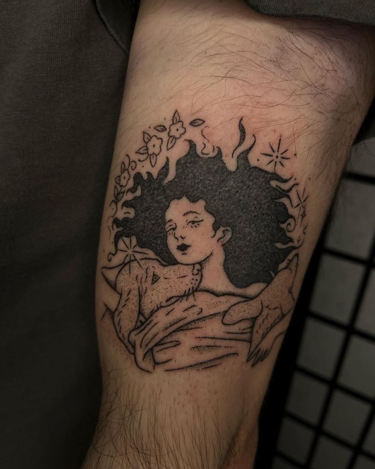 a tattoo on the arm of a man with an image of a woman's face