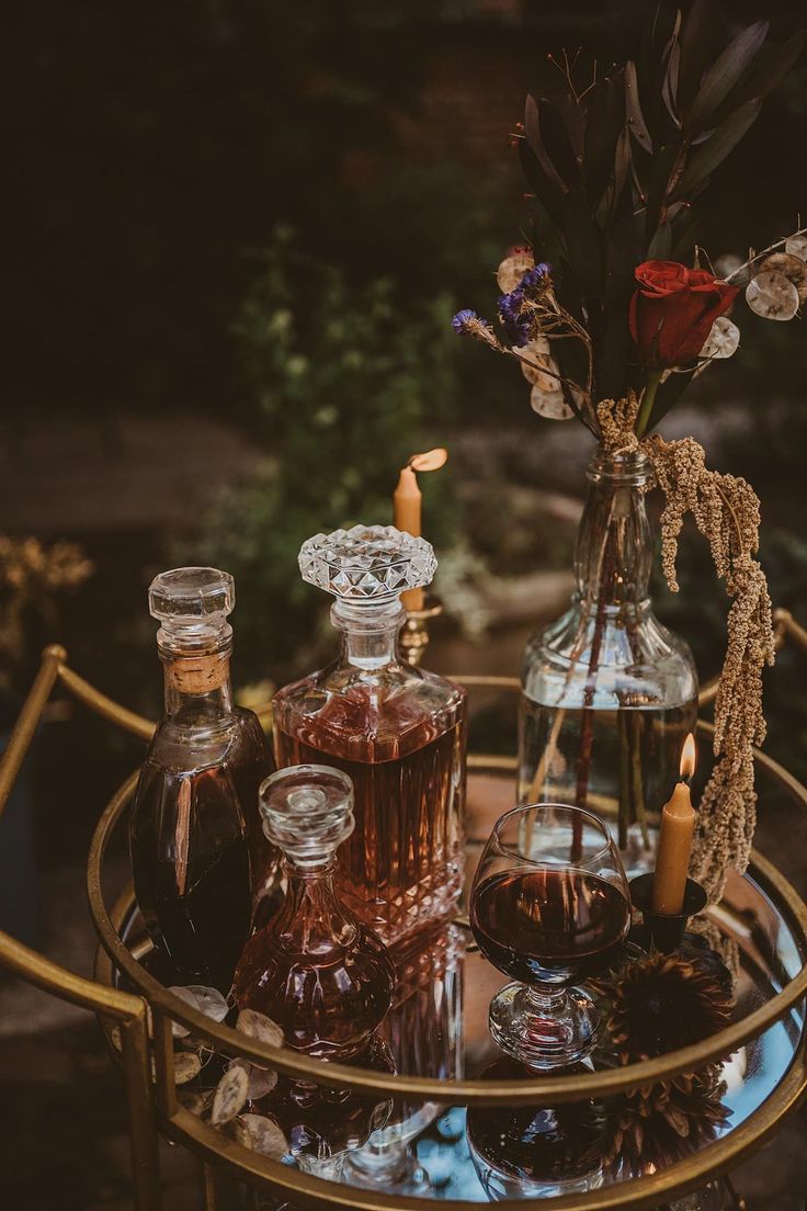 an assortment of liquor bottles and candles on a table