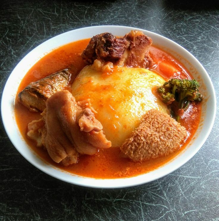 a white bowl filled with food on top of a table