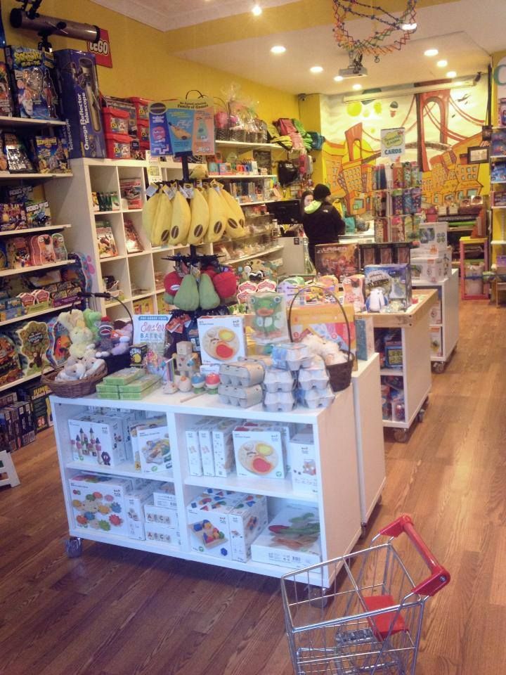 the inside of a toy store filled with toys and stuffed animals, including two children's shopping carts