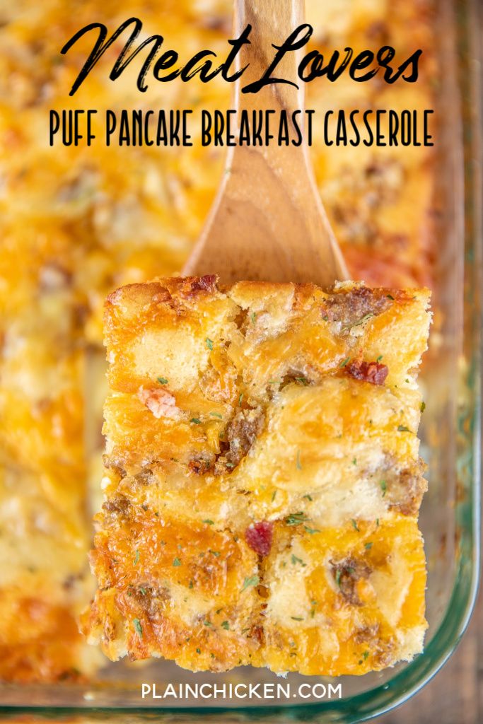 a wooden spoon in a casserole dish with meat lover's puffy pancake breakfast casserole