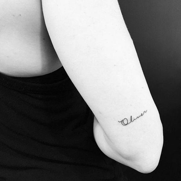 a woman's arm with the word ohana tattooed on it in cursive font