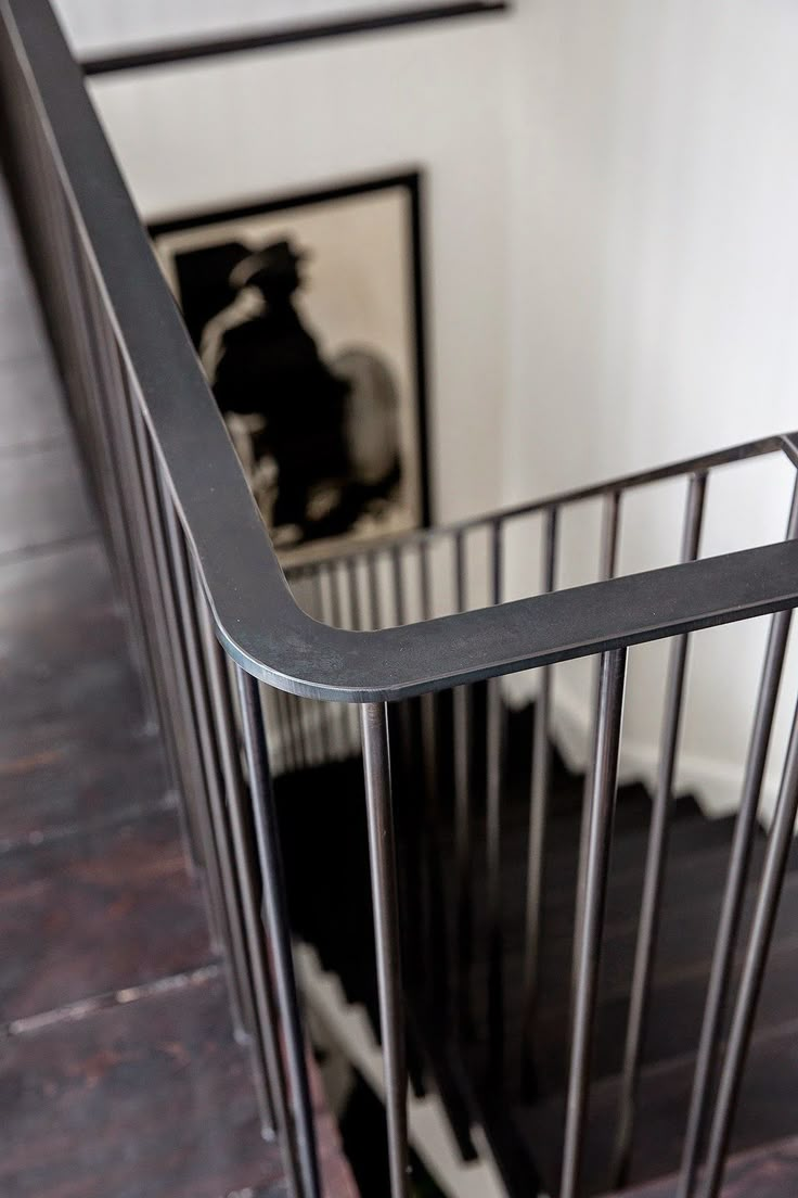 a black and white photo on the wall next to a metal railing