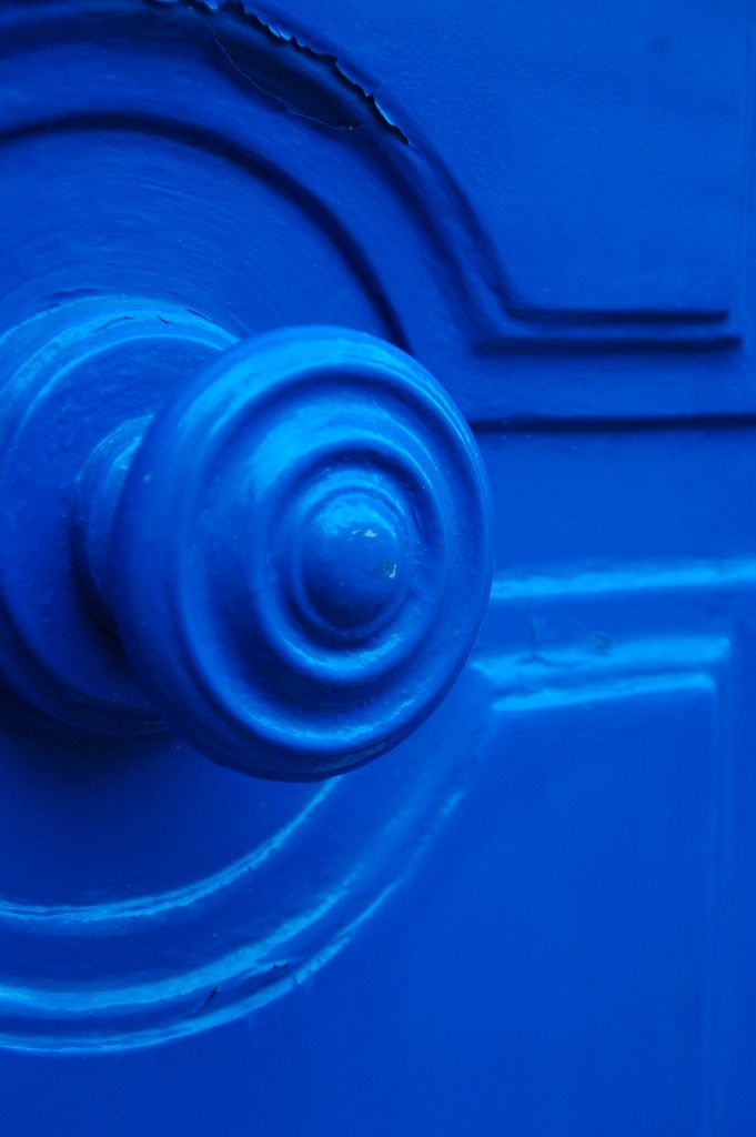 a blue door with a round handle on it