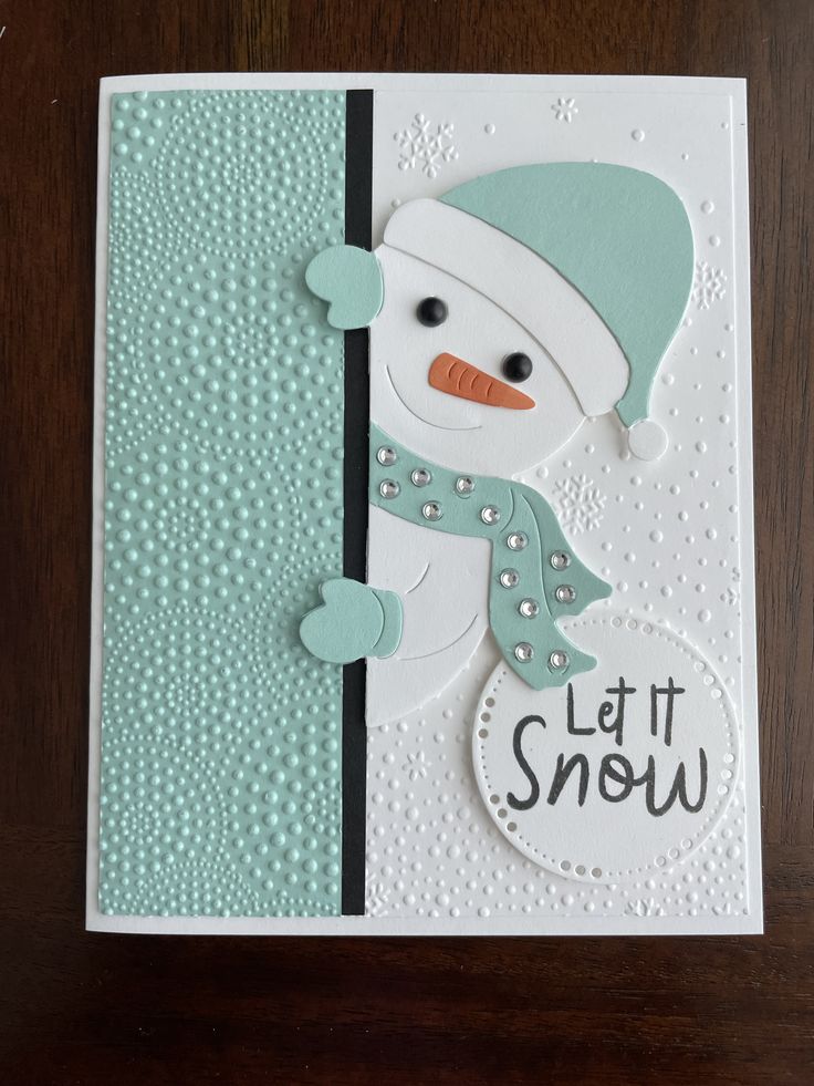 a card with a snowman on it and the words let it snow written in black ink