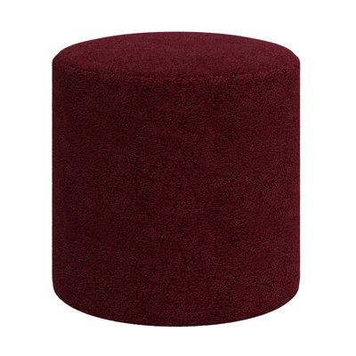 a large red ottoman sitting on top of a white floor