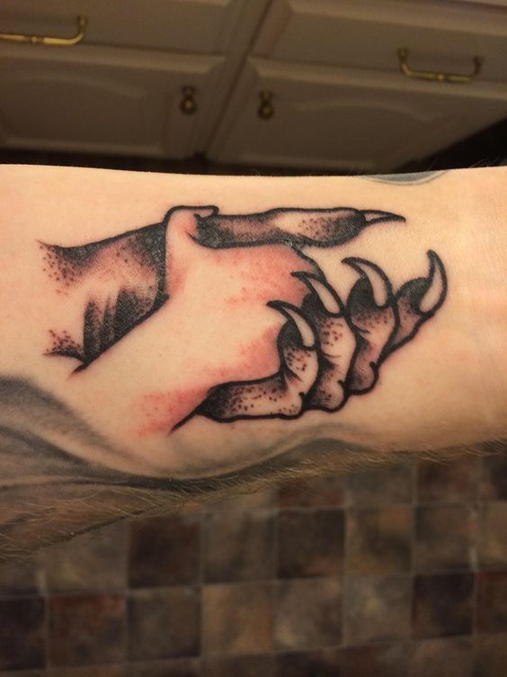 a close up of a person's arm with a tattoo design on the wrist