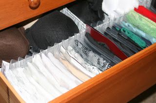 an open drawer filled with clothes and other items