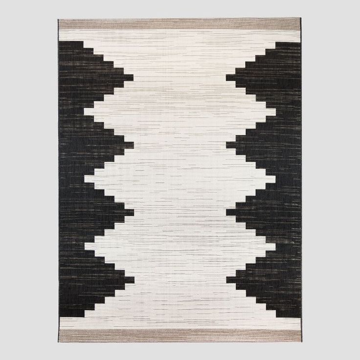 a black and white rug hanging on the wall