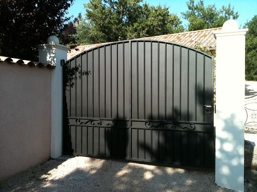 an iron gate in front of a house