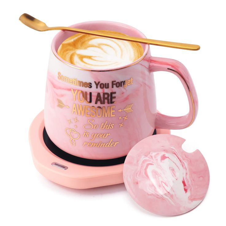 a pink coffee mug sitting on top of a saucer