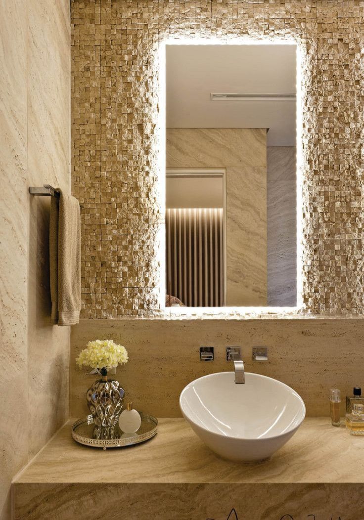 a bathroom sink sitting under a large mirror