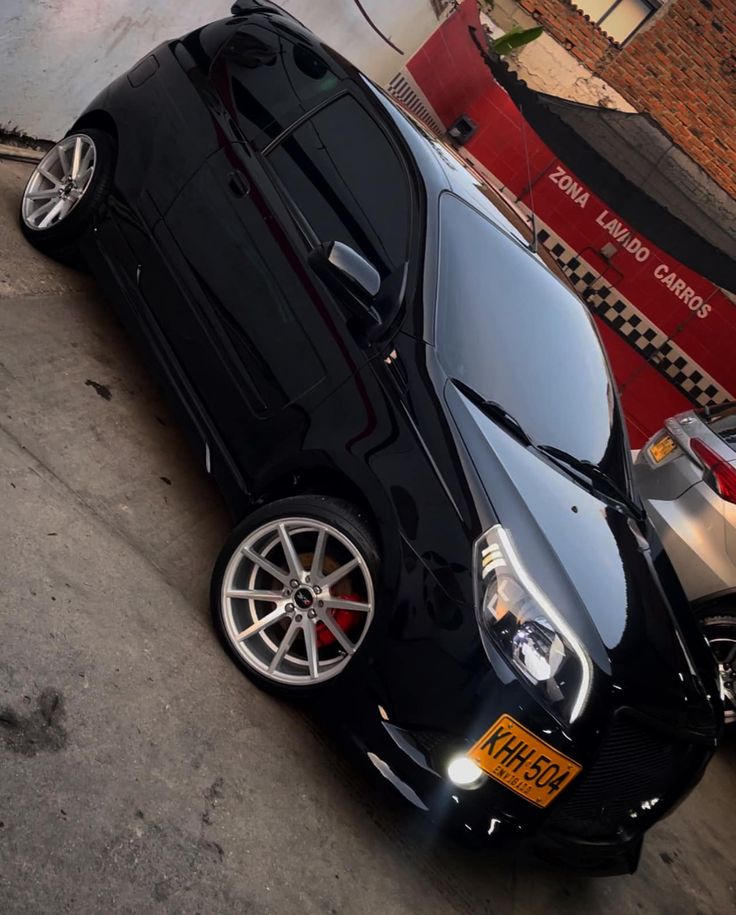 a black car parked in front of a building