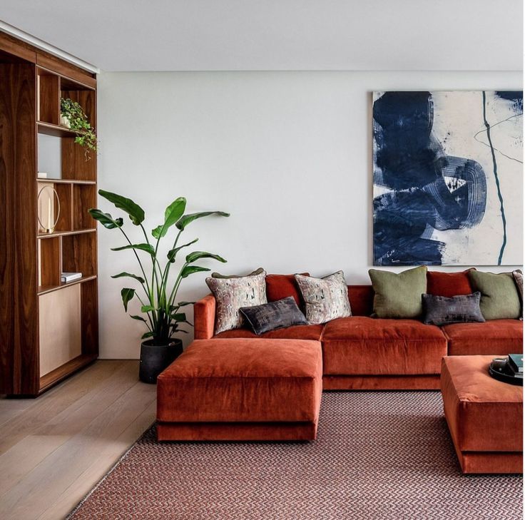 a living room filled with furniture and a painting on the wall