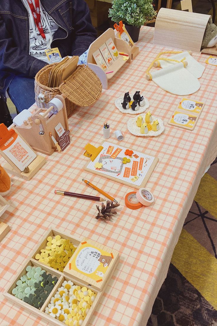 a table topped with lots of food and condiments on top of a checkered table cloth