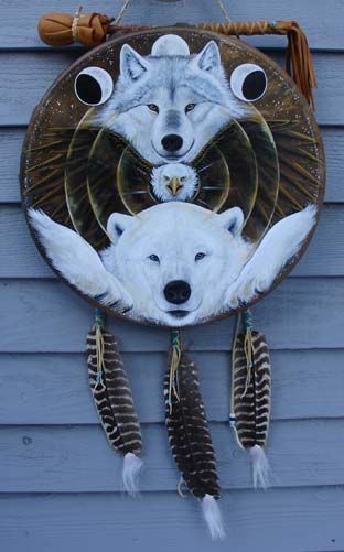 a white wolf dream catcher hanging on the side of a building