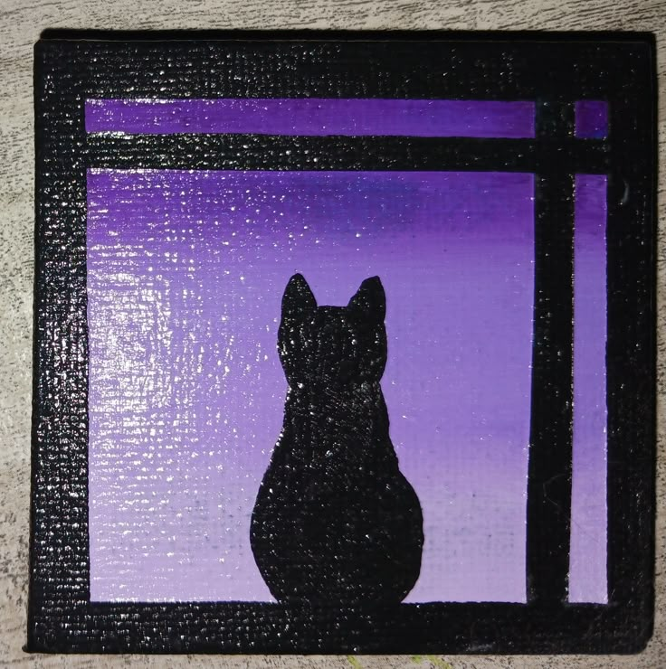 a black cat sitting in front of a purple window sill with the silhouette of a cat on it