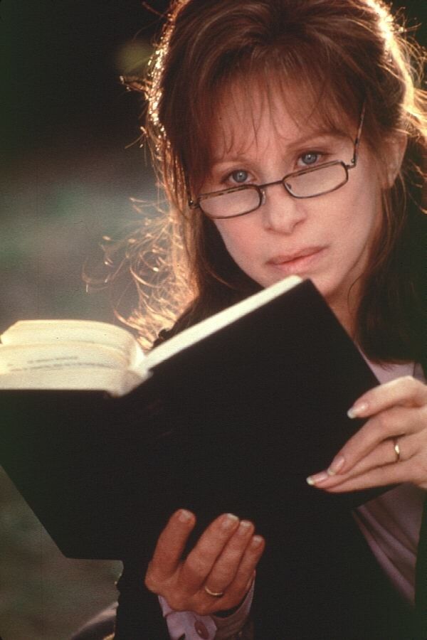 a woman wearing glasses reading a book