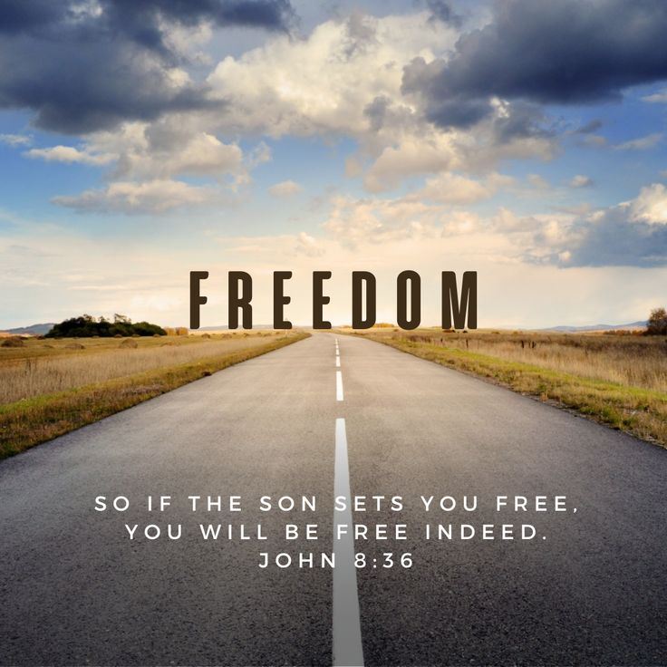 an empty road with the word freedom written on it and clouds in the background