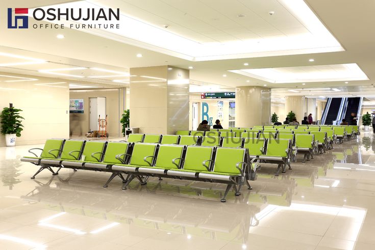 there are many green chairs in the airport waiting for their passengers to come home from work