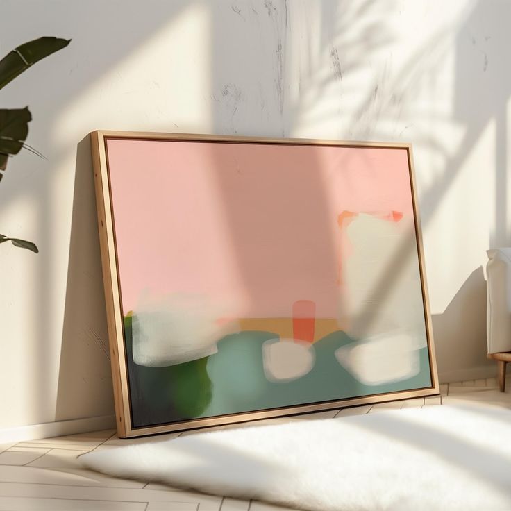 an abstract painting on the wall next to a chair and potted plant in front of it