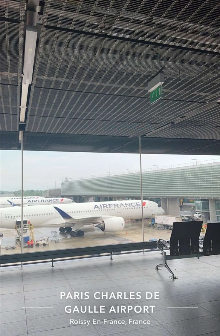 an airport terminal with two planes on the tarmac