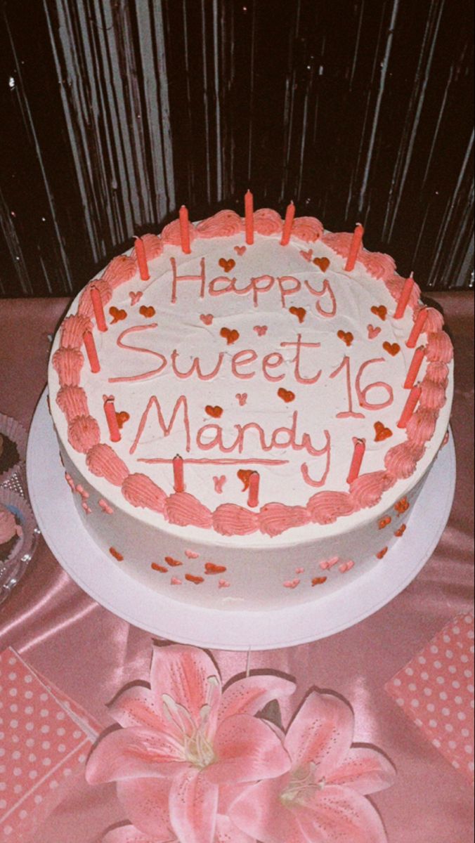 a birthday cake with the words happy sweet monday written on it and pink flowers in front