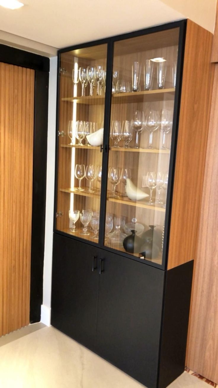 an empty glass cabinet with wine glasses in it