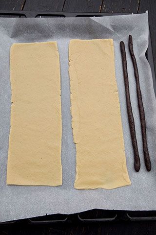 two pieces of bread sitting on top of a baking sheet next to an oven mitt