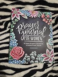 the front cover of a book with flowers and zebra print on it, sitting on top of a blanket