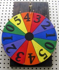 a colorful wooden clock with numbers on it