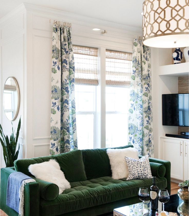 a living room filled with furniture and a flat screen tv mounted on a wall above a fireplace