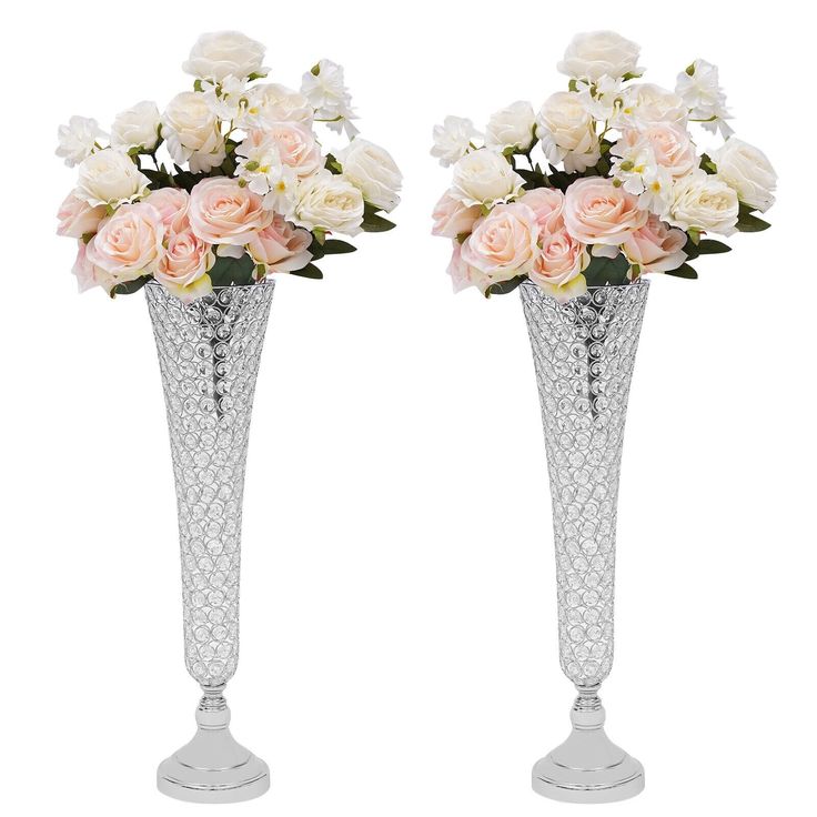 two tall vases with flowers in them on a white background, one has pink roses and the other is white