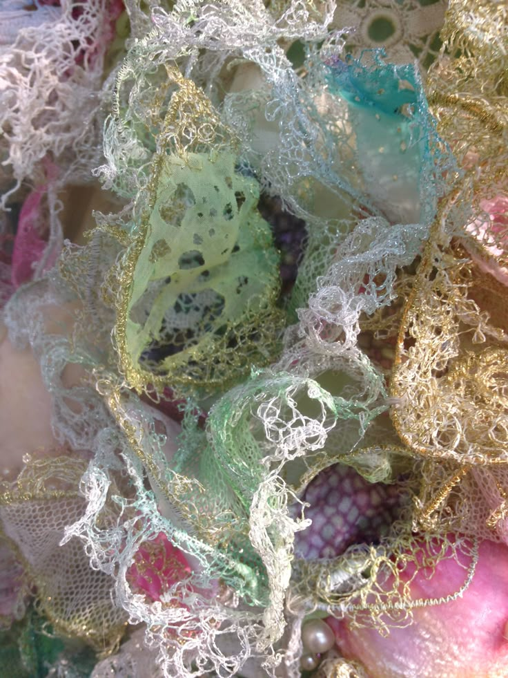 many different colored laces and beads are piled on top of each other in this close up photo