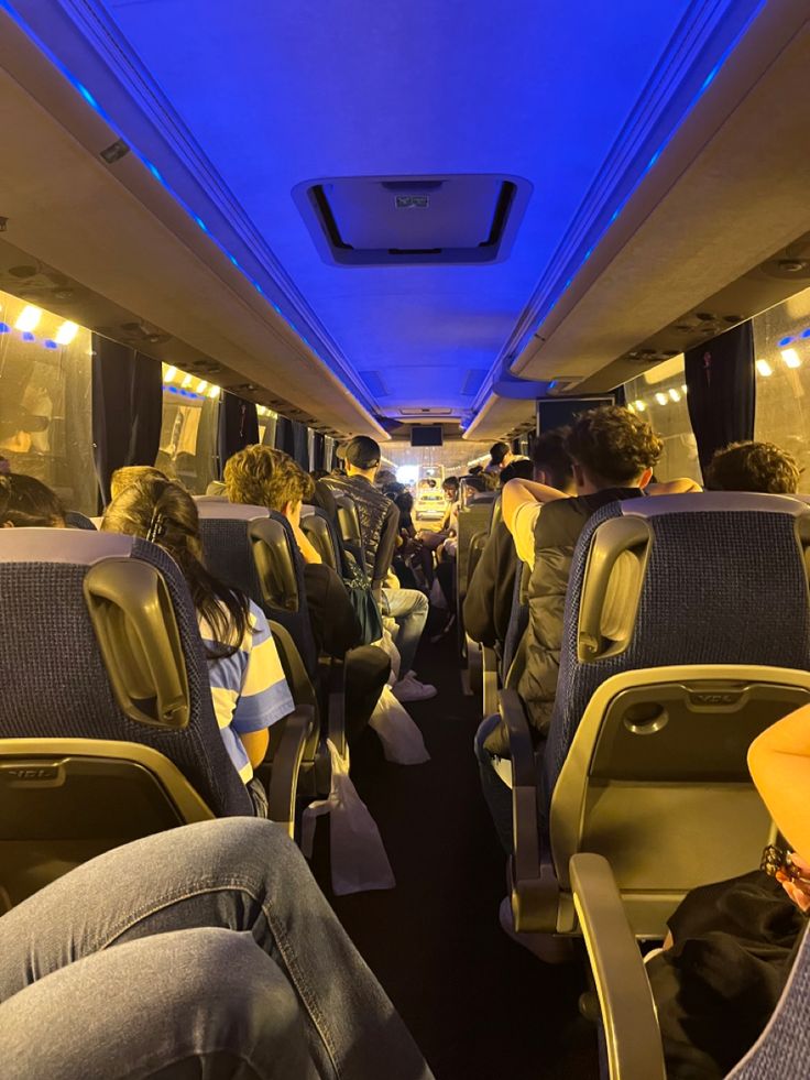 the inside of an airplane with people sitting on seats