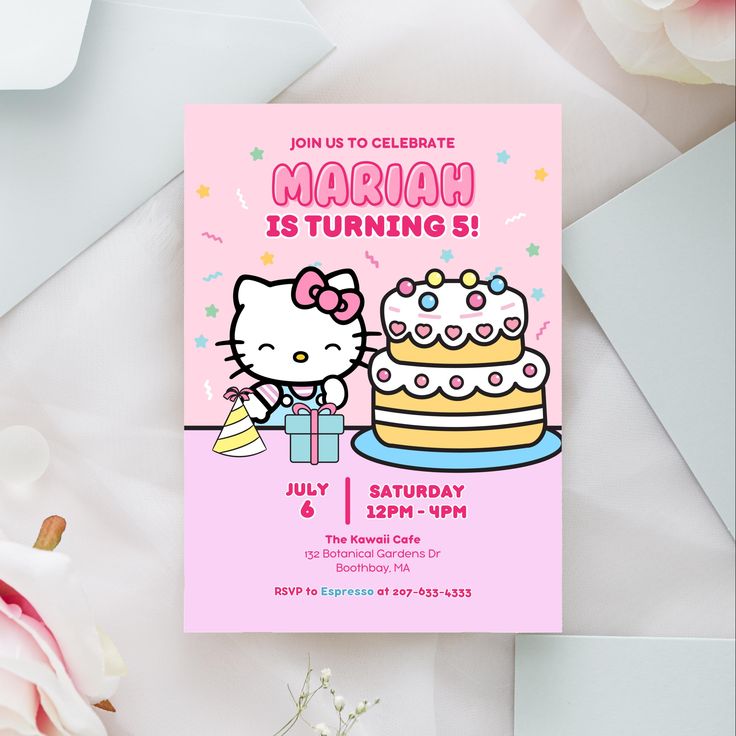 a hello kitty birthday party with a cake and flowers on the table next to it