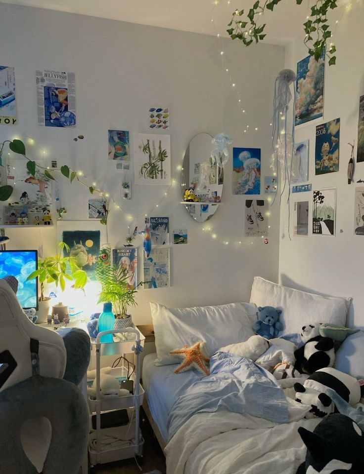 a bedroom with pictures on the wall and stuffed animals