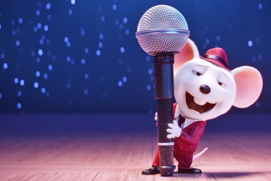 a cartoon mouse holding a microphone on stage