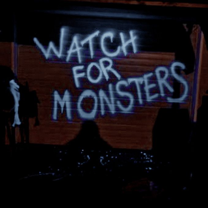 the words watch for monsters are spray painted on a wall in front of a stage