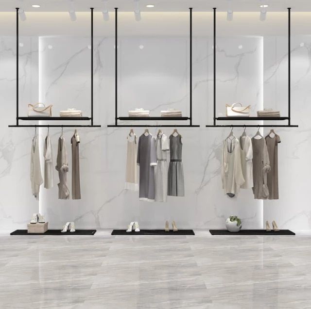 an image of clothes on racks in a store