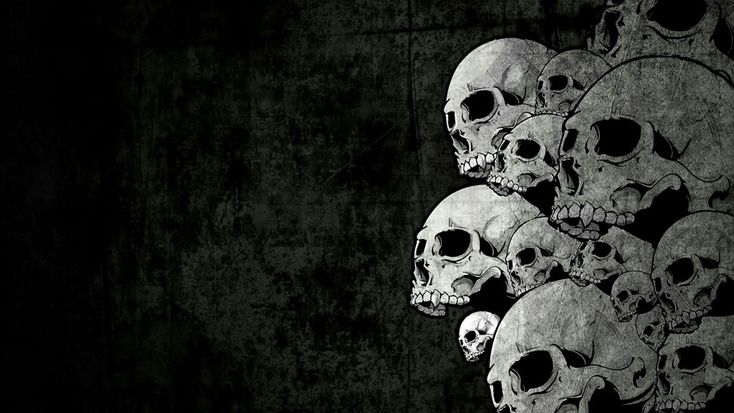 a bunch of skulls that are sitting in the dark