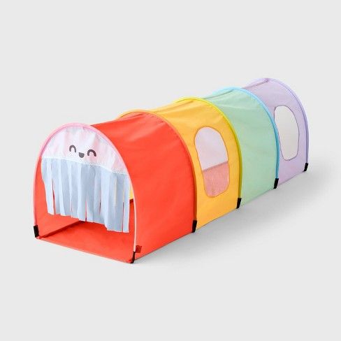 a colorful play tunnel with four different colors and designs on the front, one has a white