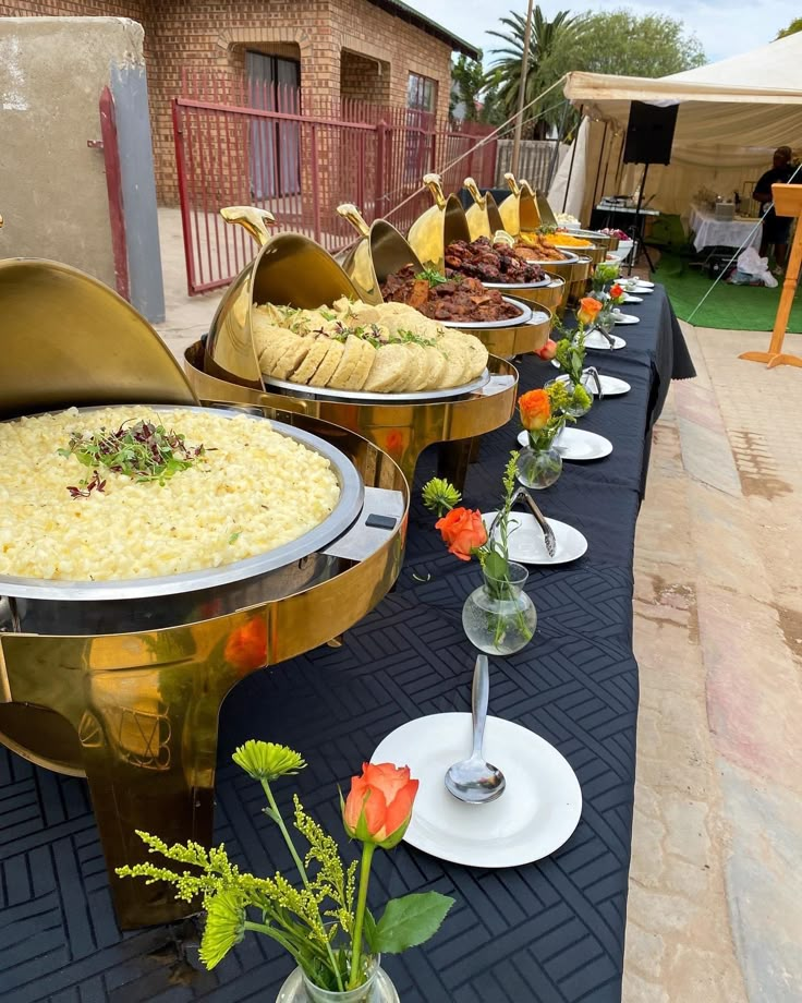 there are many different types of food on the table at this outdoor event that is ready to be eaten