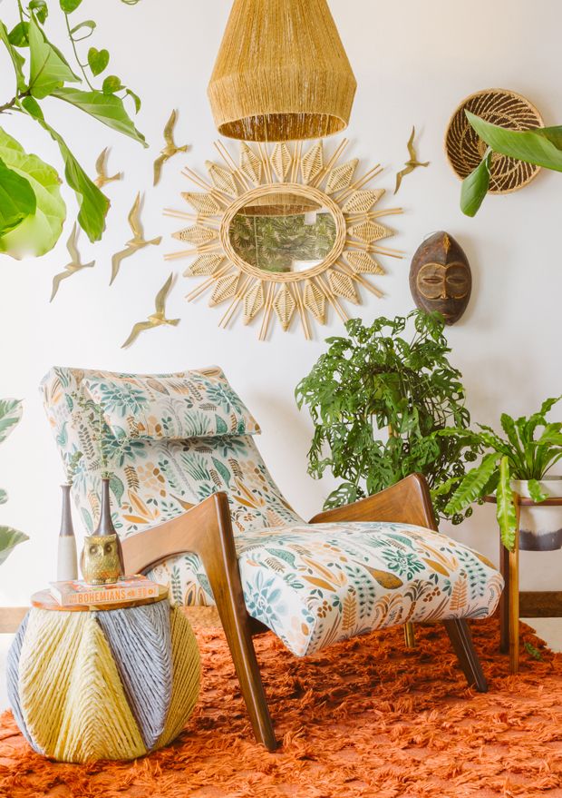 a living room filled with furniture and plants