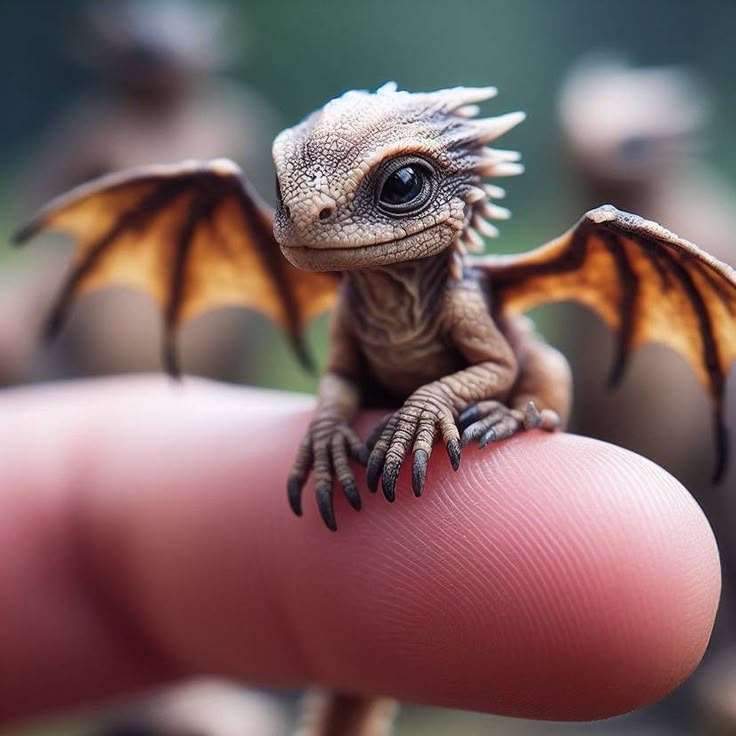 a tiny lizard sitting on top of a persons finger