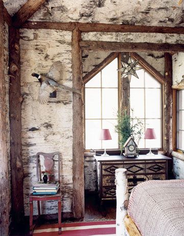 a room with a chair, mirror and table in it